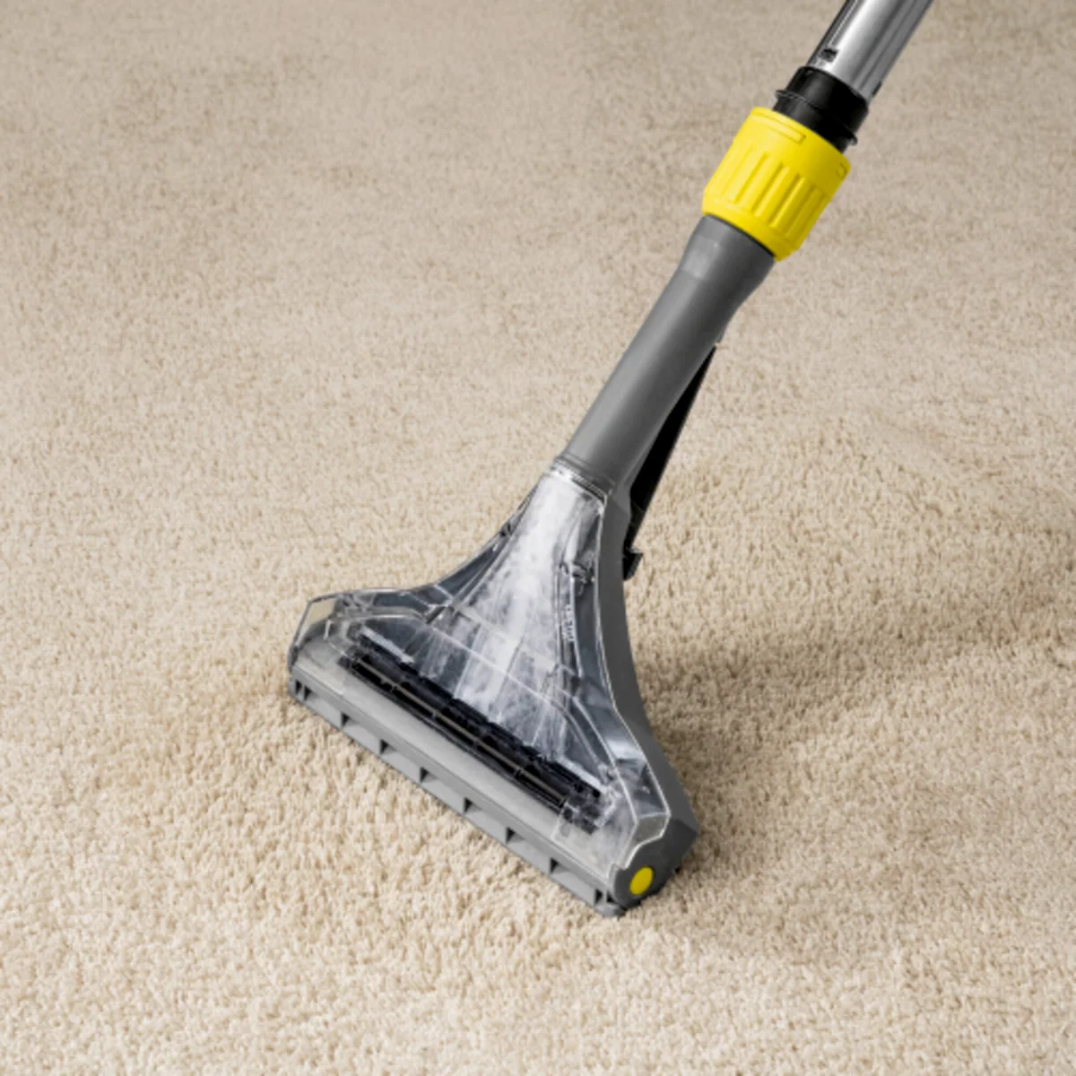 Kärcher floor tool extracting dirt and cleaning solution from a light-coloured carpet