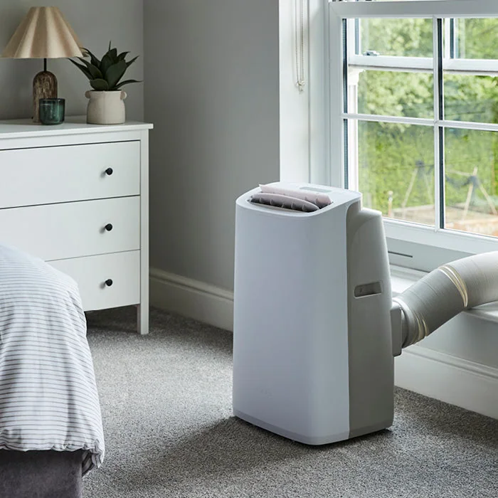 Meaco Cirro 12,000 BTU portable air conditioner installed beside a bedroom window